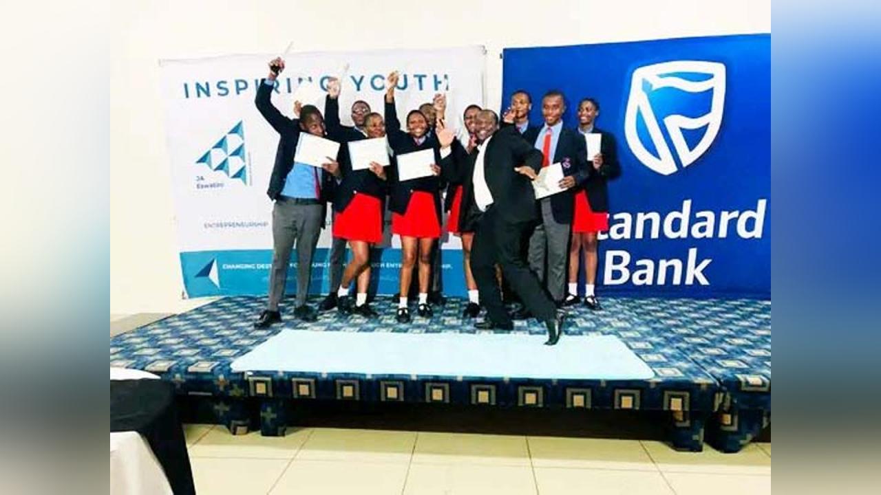 Vulamasango High School students celebrating with their certificates on stage